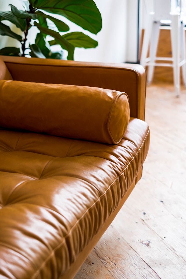 One half of a brown leather couch