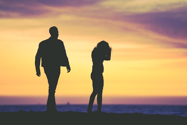 Silhouette of a man and woman separating