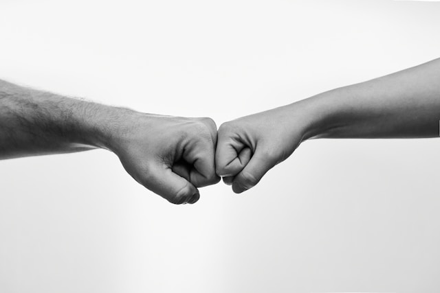Two hands doing a fistbump