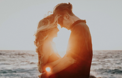 Couple in sunset, foreheads touching