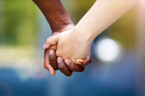 Two hands holding each other