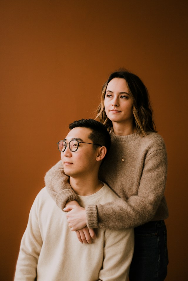 Woman standing behind man