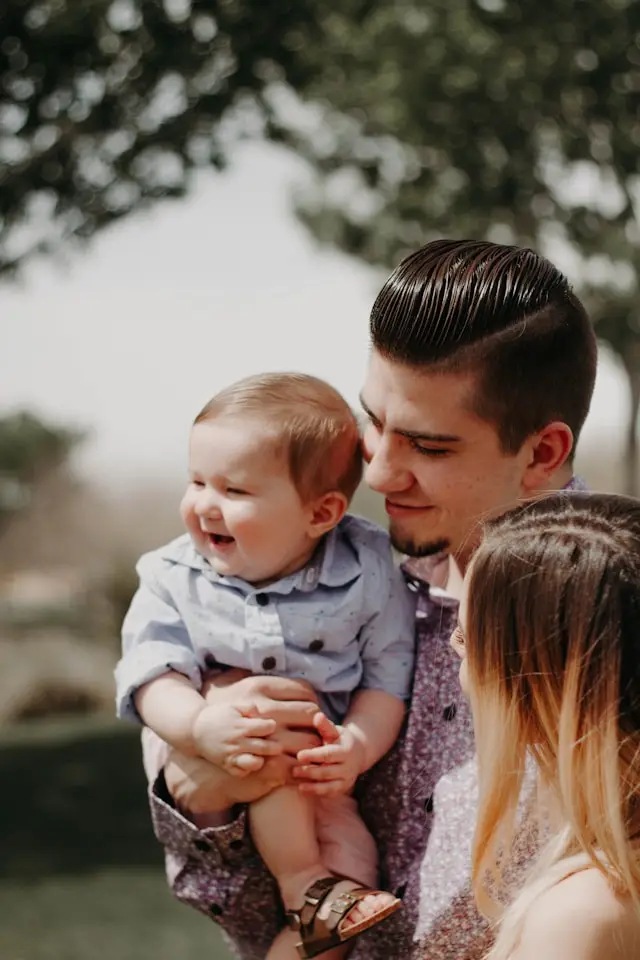 Father holding smiling child
