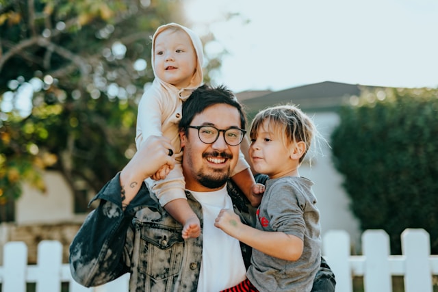 Dad with children on shoulders